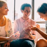 group of friends painting nails and laughing