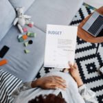 a woman creates a budgeting spreadsheet as she learns how to create a budget.