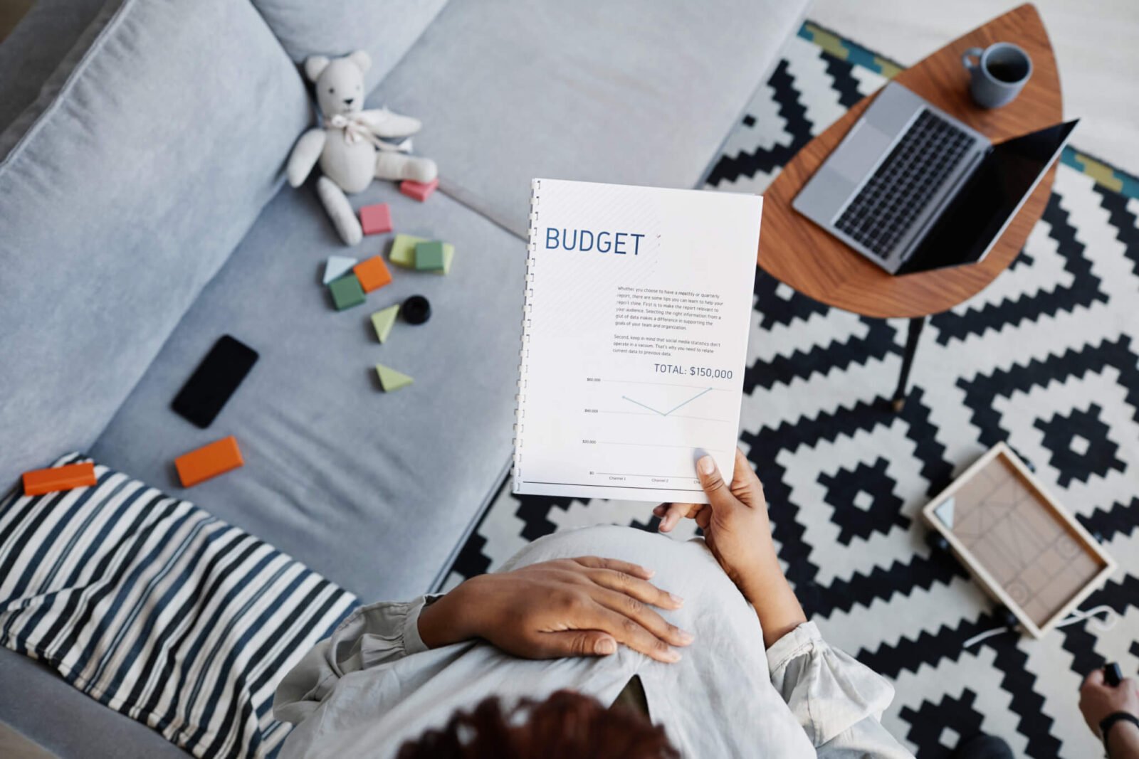 a woman creates a budgeting spreadsheet as she learns how to create a budget.