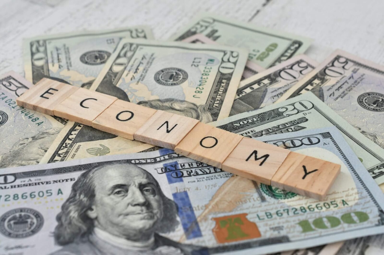 The word economy spelled out over a pile of money.