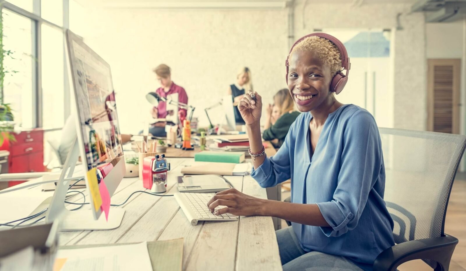 women siting in front of a computer with headphones on