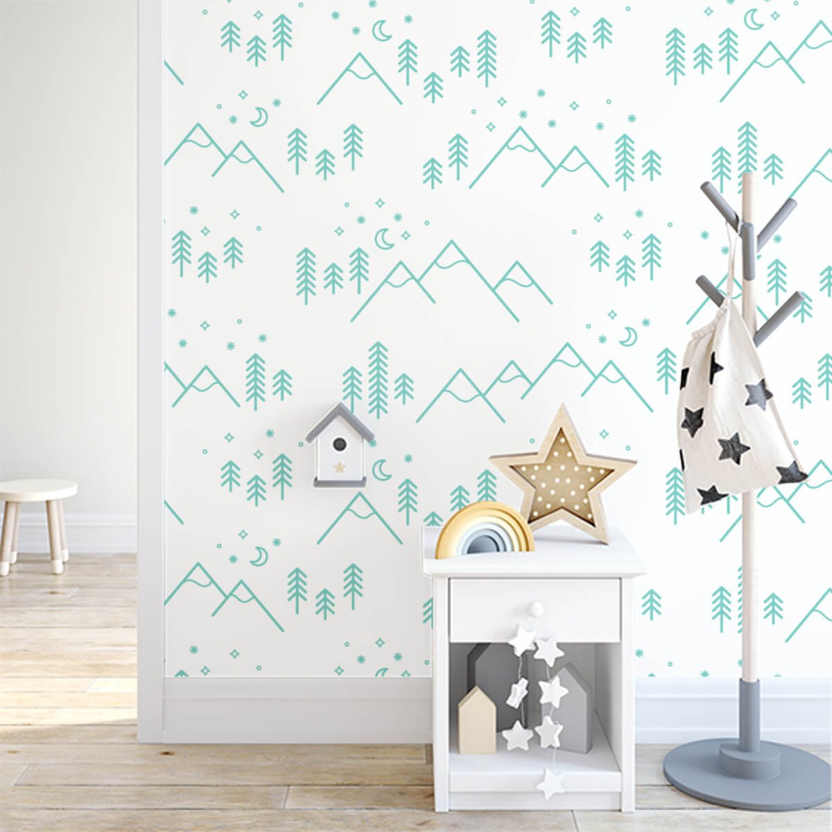 kids room with a coatrack, birdhouse, bedside table and star decorations. Wallpaper features a mountain scene with stars hanging overhead