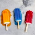 Three popsicles are pictured. They are melting.