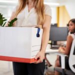 laid off employee leaving with box of belongings