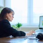 woman looking at her investment allocation on computer