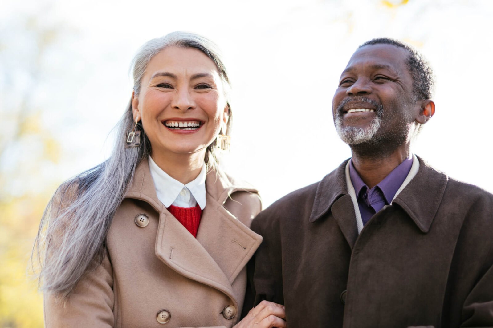 retired couple dressed up and smiling