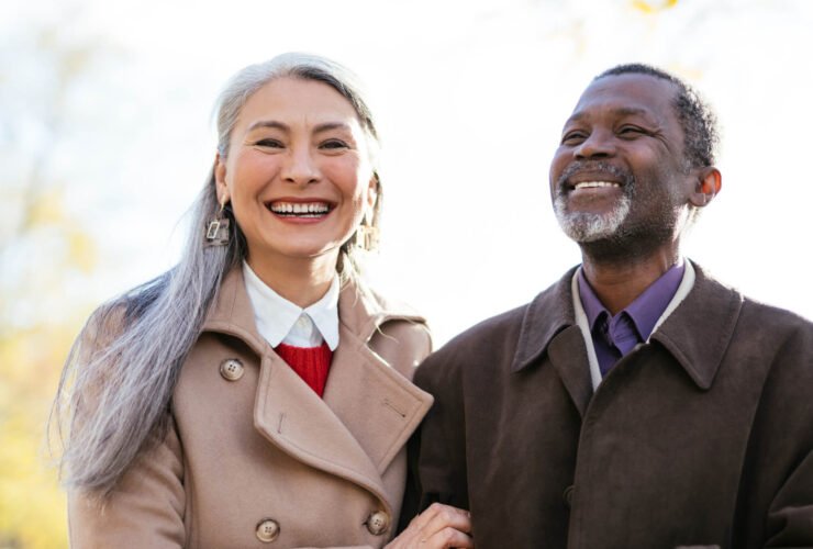 retired couple dressed up and smiling