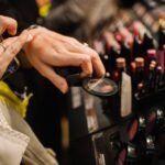 This is a close up of a woman shopping for makeup and testing it on her hand.