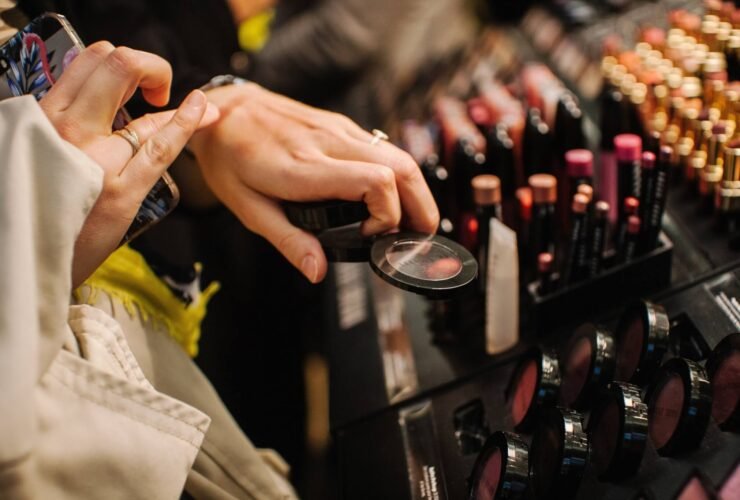 This is a close up of a woman shopping for makeup and testing it on her hand.