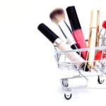 This is an image of a small shopping cart, filled with beauty products.