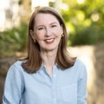 Headshot of Gretchen Rubin wearing blue and smiling at the camera.