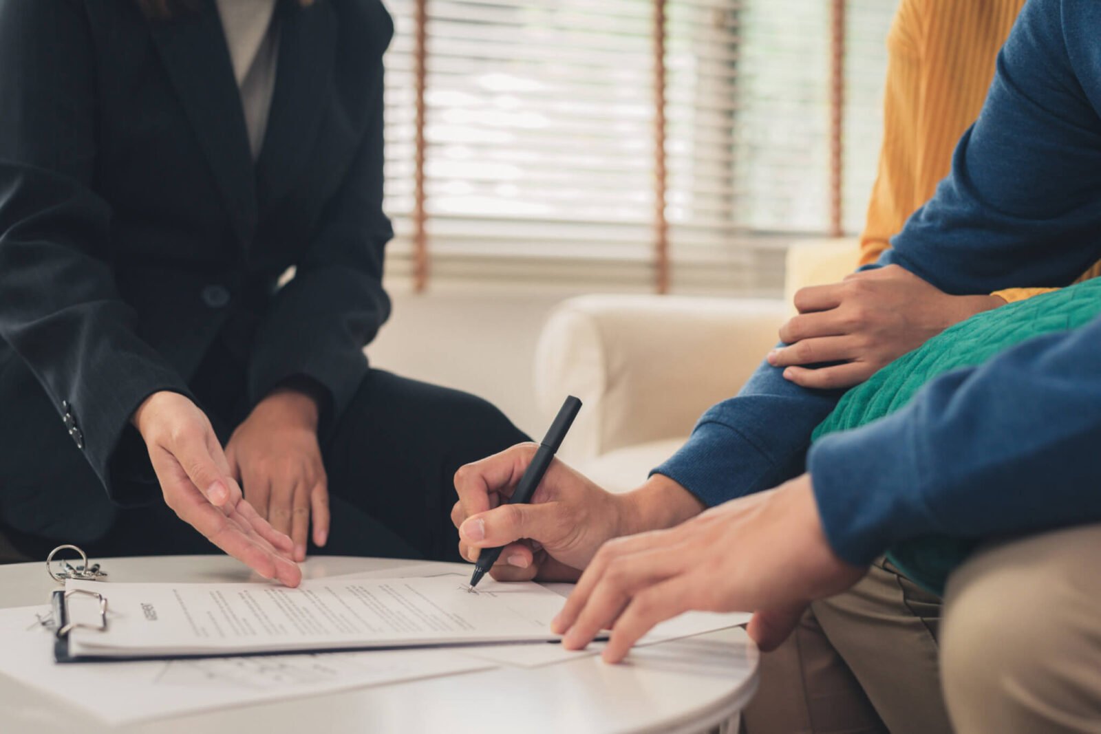 Couple signing estate planning documents.