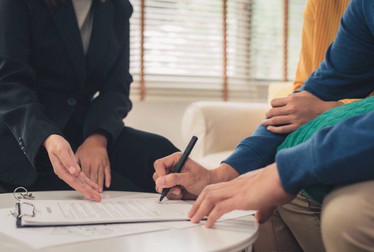 Couple signing estate planning documents.