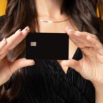 woman holding up a credit card