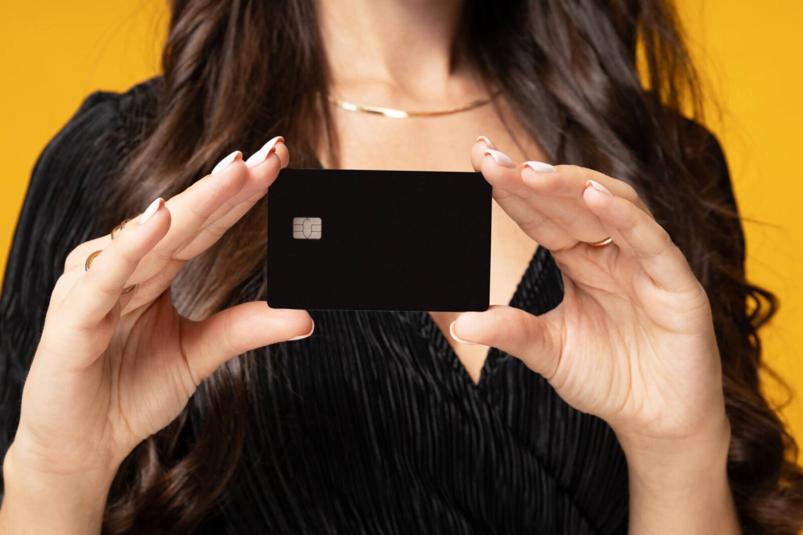 woman holding up a credit card