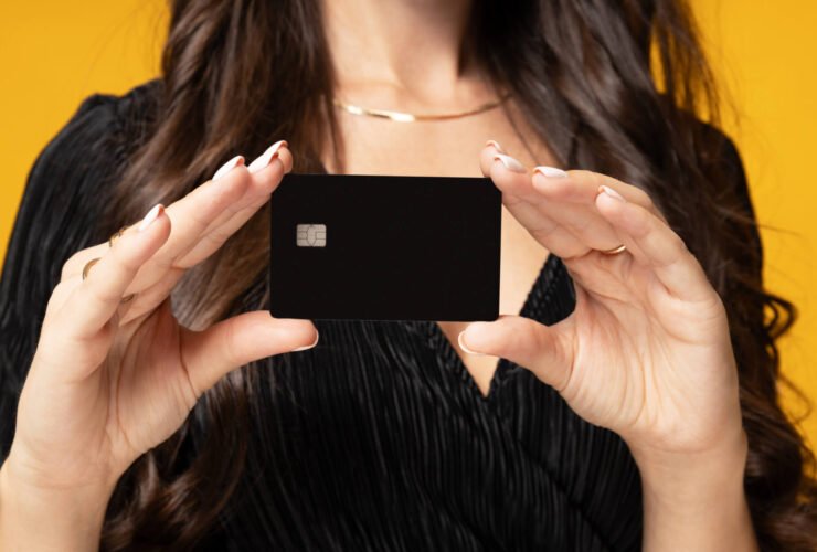 woman holding up a credit card