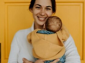 Smiling woman holding her baby.