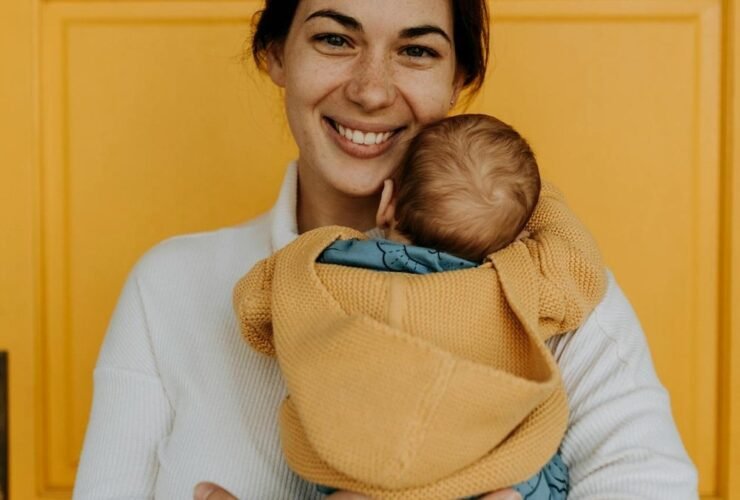 Smiling woman holding her baby.