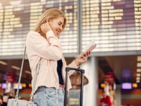Girl in a airport. Blonde with a documents. Lady in a black t-shirt