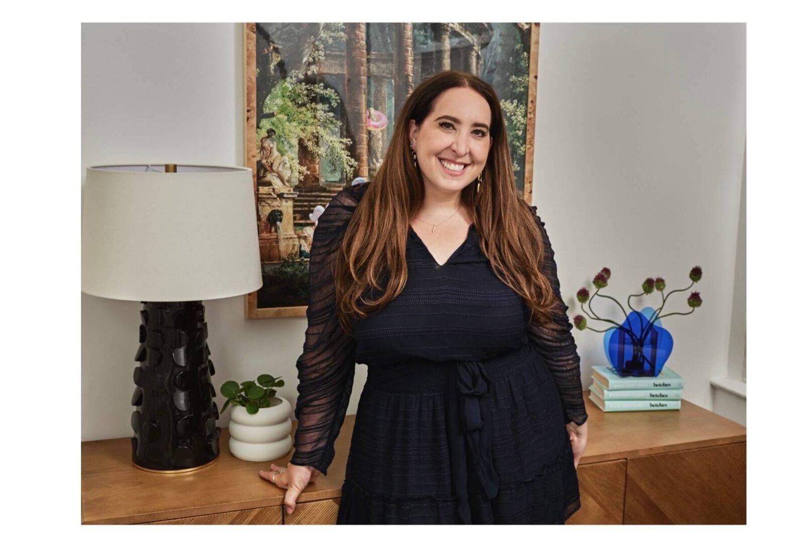Sami Sage of Betches Media stands and smiles at the camera wearing a black dress.