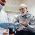 Handsome old man talking to the dendist. Two men in the dentist