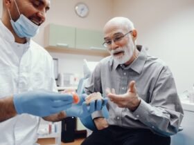 Handsome old man talking to the dendist. Two men in the dentist