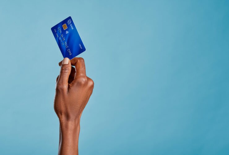 Close up of a woman's hand holding a bank credit card to make a payment with her first credit card